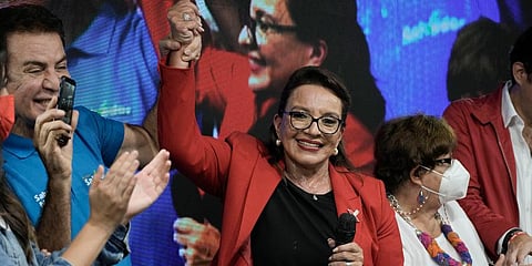 Free Party presidential candidate Xiomara Castro has her hand raised by her running mate Salvador Nasralla after general elections, in Tegucigalpa, Honduras, Sunday, Nov. 28, 2021. (Photo | AP)