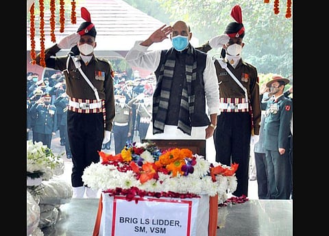 Defence Minister Rajnath Singh pays last respects to the mortal remains of Brigadier LS Lidder. (Photo | ANI)