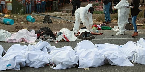 Bodies in bodybags are placed on the side of the road after an accident in Tuxtla Gutierrez, Chiapas state, Mexico. (Photo | AP)