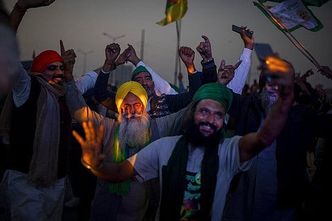 A group of Indian farmers dance at the protest site as they started to dismantle temporary structures used during protests in Ghazipur, outskirts of New Delhi. (Photo | AP)