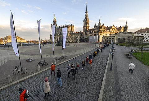 Numerous people line up in front of the Semper Opera on Theaterplatz in Dresden, Germany, Friday, Dec. 10, 2021 to get vaccinated. (Photo | AP)