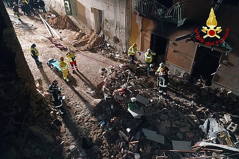 Italian firefighters and rescuers search for survivors among the rubble of a collapsed building, in Ravanusa, Sicily, Italy. (Photo | AP)