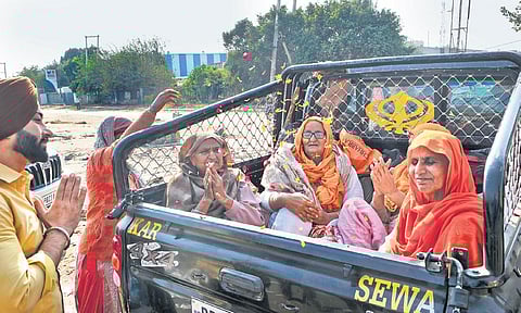 Farmers cheer as they leave the protest site at Singhu border in New Delhi on Saturday. (Photo | Shekhar Yadav)