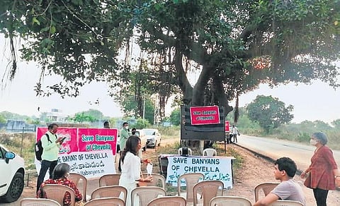 Green activists organise a protest meeting to exert pressure on the State government to withdraw its decision to fell about 900 century-old banyan trees on the Moinabad-Chevella highway | Express