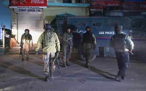 Security personnel stand guard near the site of a militant attack in Zewan on the outskirts of Srinagar. (Photo | PTI)