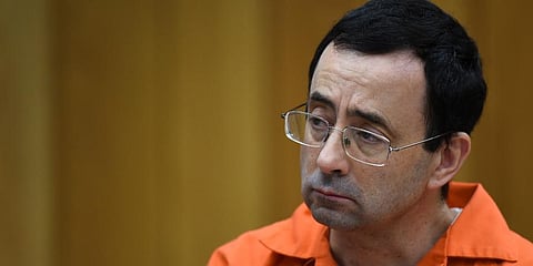 FILE - Larry Nassar listens as Rachael Denhollander gives her victim impact statement, Feb. 2, 2018, in Eaton County Circuit Court in Charlotte, Michigan. (Photo | AP)
