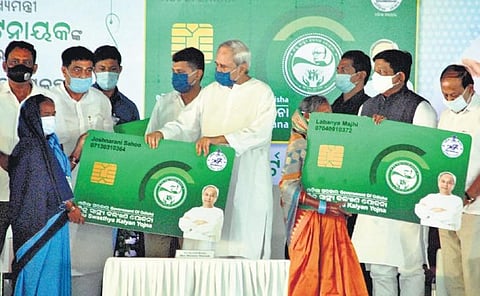 Chief Minister Naveen Patnaik presenting BSKY smart health card to a beneficiary in Cuttack on Monday. (Photo| EPS)