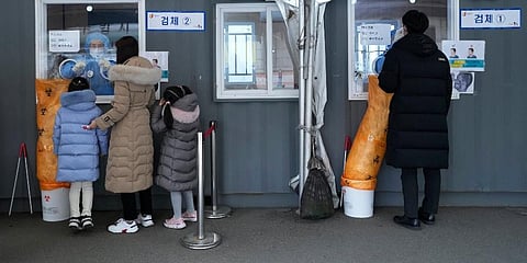 Medical workers take nasal samples from people at a makeshift coronavirus testing site in Seoul, South Korea. (Photo | AP)
