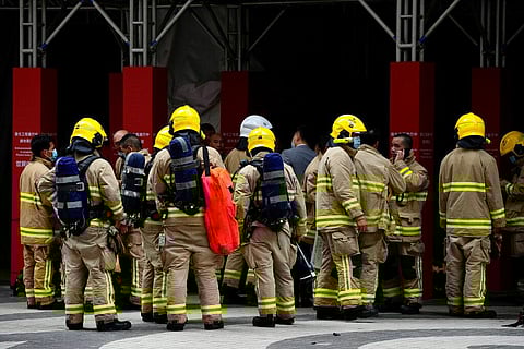 Firefighters stand by outside the World Trade Centre in Causeway Bay shopping district of Hong Kong. (Photo | AP)