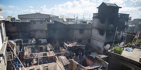 Residents stand amid their homes damaged by a gasoline truck that overturned and exploded in Cap-Haitien, Haiti. (Photo | AP)