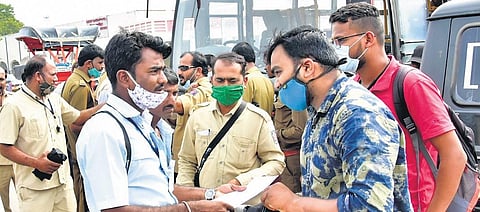 Officials guide the candidates to reach the exam centre in Kalaburagi.