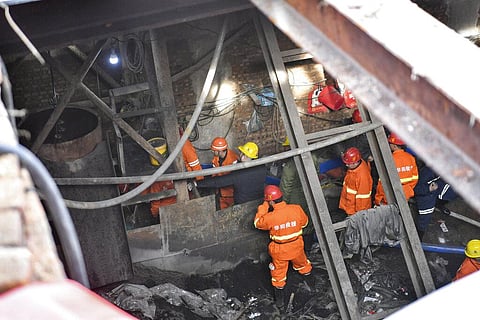 In this photo released by China's Xinhua News Agency, rescuers work at a coal mine at Duxigou Village of Xixinzhuang Township in Xiaoyi City in northern China's Shanxi Province. (Photo | AP)
