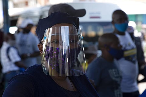 FILE | People wear face masks to protect against COVID-19 before boarding a minibus taxi in Johannesburg. (Photo | AP)