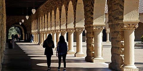 FILE — Students walk on the Stanford University campus in Stanford, California, March 14, 2019.