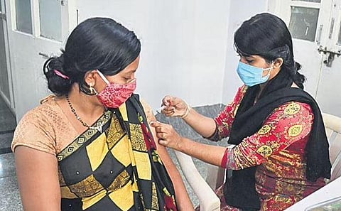 A health worker administers Covid vaccine to a woman. (Photo | Shriram BN, EPS)