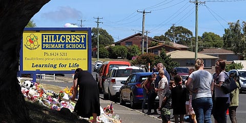 Flowers and tributes are seen outside Hillcrest Primary School in Devonport, in the island state of Tasmania, Australia Friday, Dec. 17, 2021. (Photo | AP)