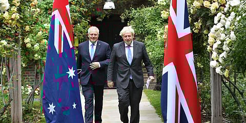 FILE - Britain's Prime Minister Boris Johnson, right, walks with Australian Prime Minister Scott Morrison after their meeting, in the garden of 10 Downing Street in London, June 15, 2021. (Photo | AP)