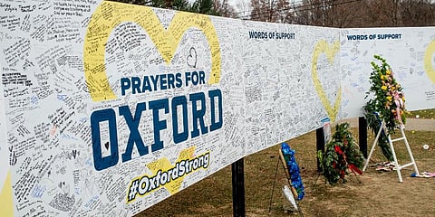 FILE - Handwritten messages are left at the memorial site at the memorial site on Tuesday, Dec. 7, 2021, outside Oxford High School in Oxford, Michigan.