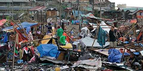Residents salvage what's left of the their damaged homes caused by Typhoon Rai in Cebu city, central Philippines on Friday, Dec. 17, 2021. (Photo | AP)
