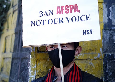 A Naga holds a placard during a rally protesting the killings of fourteen civilians by Indian army soldiers earlier this month, in Kohima. (Photo | AP)