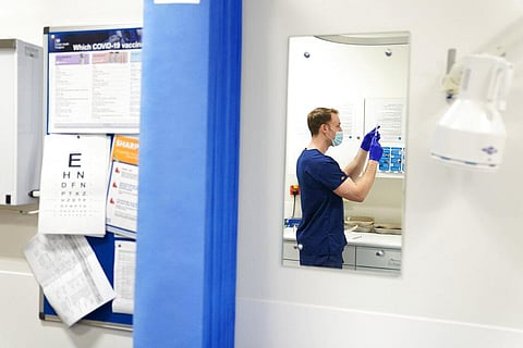 A COVID-19 vaccination is prepared as a 24-hour 'jabathon' takes place at an overnight walk-in vaccine clinic at the Morris House GP practice in the Haringey borough of London. (Photo | AP)