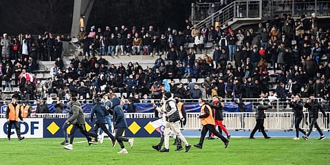 Supporters run on the pitch during a French Cup match between Lyon and Paris FC at the Charlety stadium. (File photo| AFP)