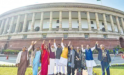 Suspended Rajya Sabha MPs outside Parliament House in New Delhi on Friday. (Photo | PTI)