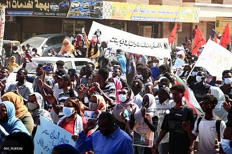 Sudanese demonstrators raise national flags and banners as they rally against the military chief who launched a coup on October 25. (Photo | AFP)