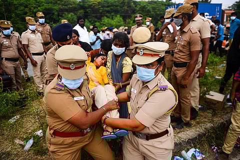 Cops carry a woman who fainted at protest in Chennai. (Photo | Debadatta Mallick, EPS)