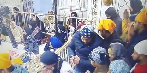 A man with yellow cloth around his head jumped inside the sanctum sanctorum of the Golden Temple. (Photo | YouTube Screengrab)