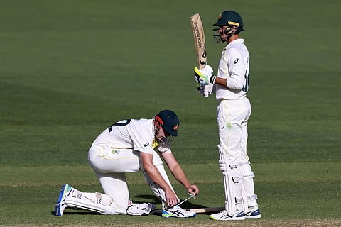 Australia's Cameron Green, left, ties his shoe as batting partner Australia's Mitchell Starc stands by during the fourth day of their Ashes cricket test match against England in Adelaide ( Photo | AP)