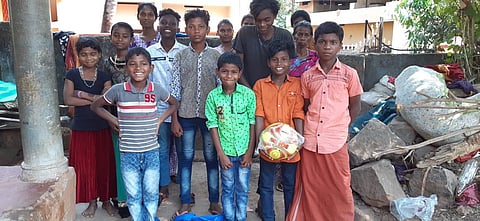 Tribal children are in a joyous mood after receiving sports kits distributed by the society