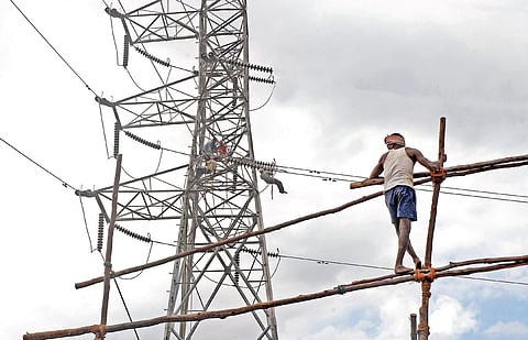 Representational image of a worker repairing an electricity line