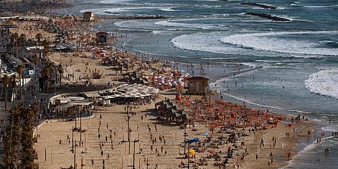 People enjoy the beach front in Tel Aviv, Israel. (Photo | AP)