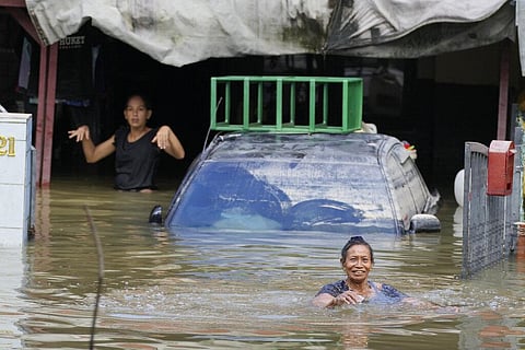 Residents are trapped at their house affected by a flood in Shah Alam, outskirts of Kuala Lumpur, Malaysia. (Photo | AP)