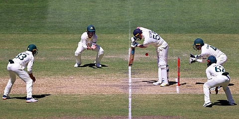 England's Ben Stokes, center, is trapped LBW by Australia's Nathan Lyon during the fifth day of their Ashes cricket test match in Adelaide, Australia, Monday, Dec. 20, 2021. (Photo | AP)