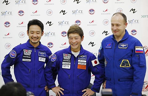 Roscosmos cosmonaut Alexander Misurkin, right, space flight participants Yusaku Maezawa, center, and Yozo Hirano attend a news conference ahead of the expedition to the ISS. (Photo | AP)