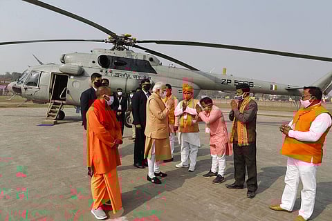 Indian Prime Minister Narendra Modi, center, greets officials as he arrives to attend a rally of women self-help groups, in Prayagraj. (Photo | AP)