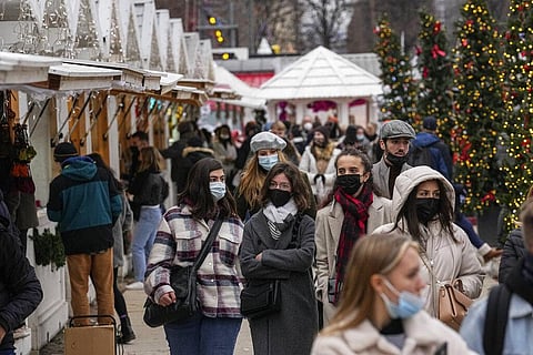Shoppers wearing face masks to protect against COVID-19 walk along the Christmas market at Tuilerie garden in Paris, France (Photo | AP)