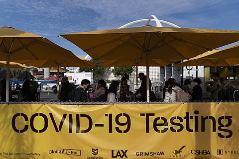 Travelers wait in line to get tested for COVID-19 at Los Angeles International Airport in Los Angeles, Monday, Dec. 20, 2021. (Photo | AP)