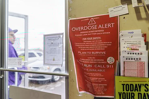 A sign calling attention to drug overdoses is posted to the door of a gas station on the White Earth reservation in Ogema, Minn., Tuesday, Nov. 16, 2021. (AP)