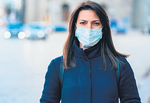 Representational image of a woman wearing a face mask.