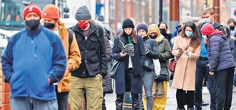 People in London queue for vaccination as Omicron cases spread rapidly (Photo | AFP)