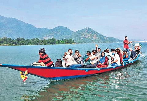 Health workers crossing Baghalati reservoir on a boat to administer Covid vaccine to villagers of Ankuli panchayat in Ganjam district (Photo | Express)
