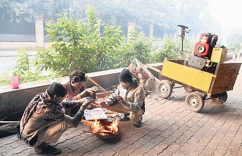 A group of locals make a small bonfire to warm themselves on a chilly Thursday morning in New Delhi | Parveen Negi