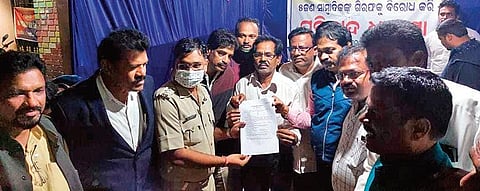 Police handing over a copy of the FIR to the agitators on Thursday. (Photo | Express)