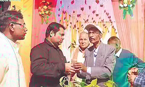 Bholaram Sinha (in white cap) feels his plants are no less than his daughter | express