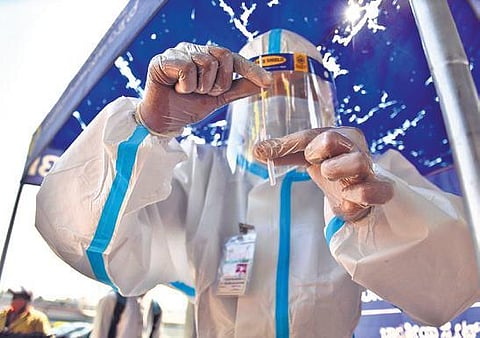 A health worker stores swab samples collected from a passenger at the KSRTC Bus Station on Saturday  |  Shriram BN