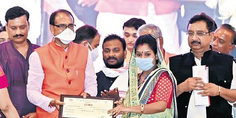 CM Shivraj Singh Chouhan with a beneficiary of the scheme   | express