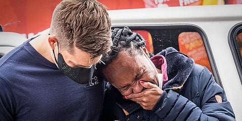 A woman is comforted outside the historical home of Anglican Archbishop Desmond Tutu, in Soweto, Johannesburg, South Africa. (Photo | AP)